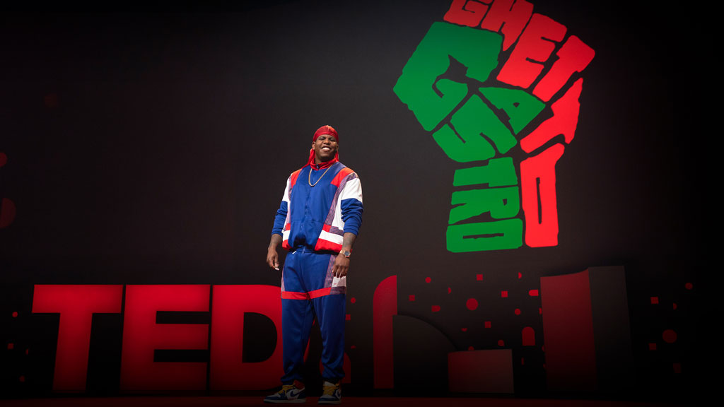 Photograph of Jon Gray on stage at TED2019