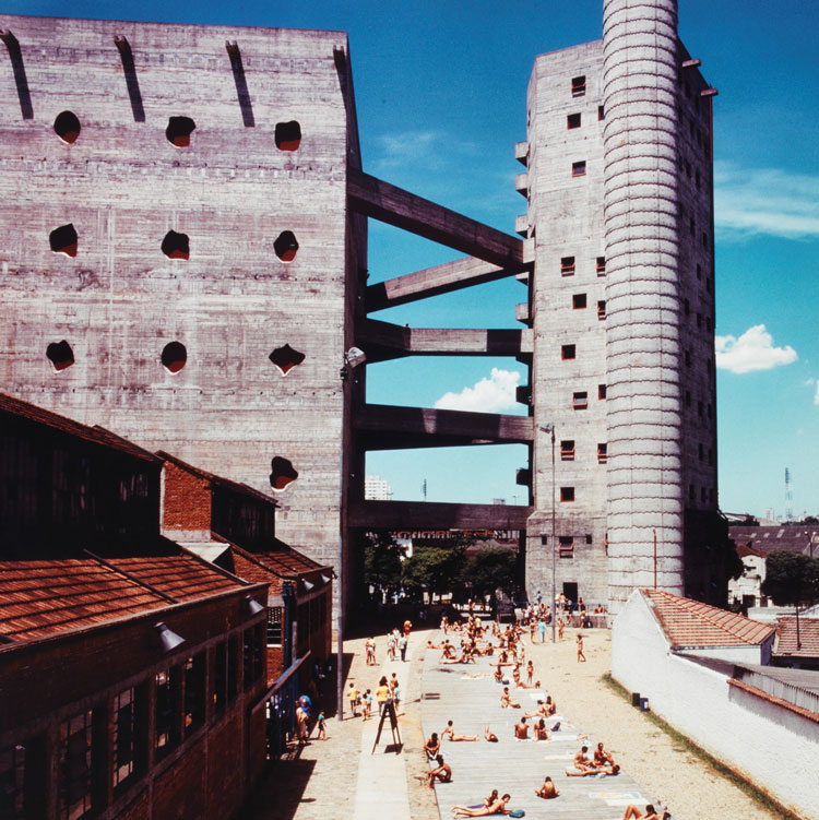Historic photo showing the architecture of the SESC Pompeia Deck with visitors sunbathing and relaxing