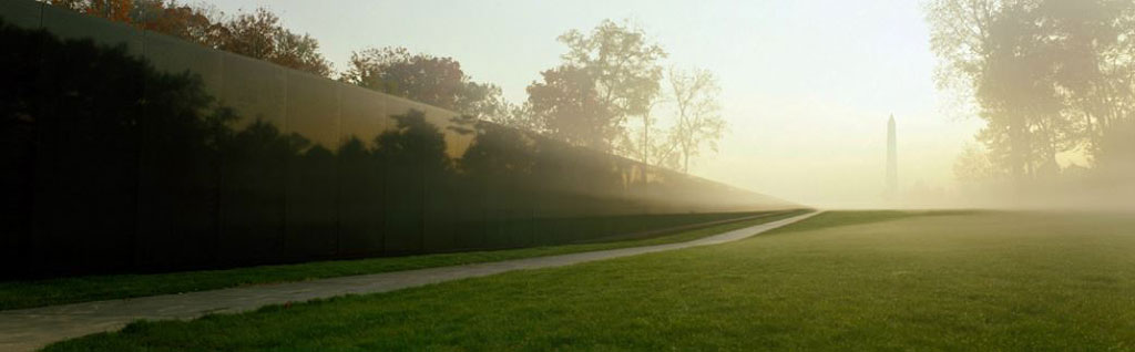 Photograph of artist Maya Lin's Vietnam Veterans Memorial with the Washington Monument in the background