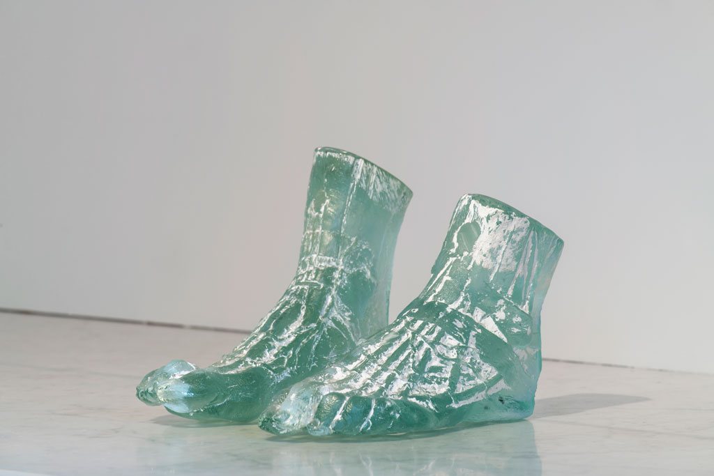 Photograph of the sculpture Untitled, featuring two semi-translucent feet with ankles