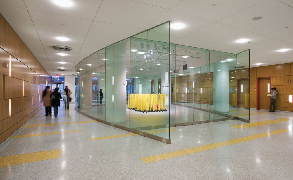 Photograph of the completed Humanities Gallery that showcases how collaborating artists can showcase work to passersby traveling around the transparent glass walls