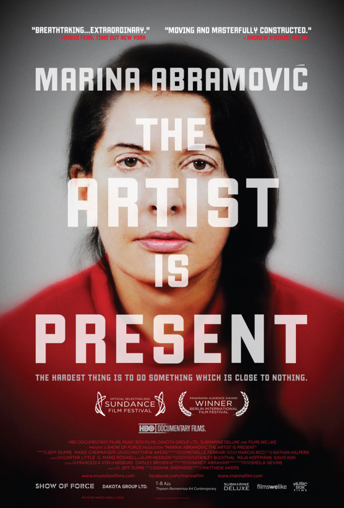 The movie poster for Marina Abramović: The Artist Is Present. The image shows the artist looking straight at the viewer, how she would have appeared to visitors who participated in the performance of The Artist Is Present