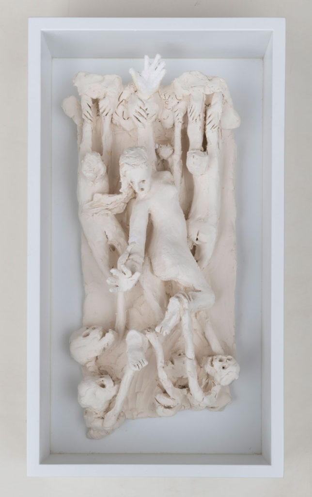 Unpainted sculpture showing similar elements to the final painting including a reaching woman and skeletons