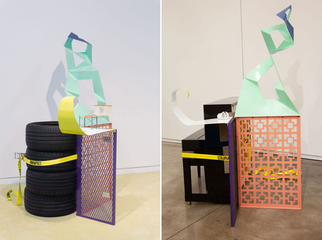 Two views of Assist #3 A Chord, a sculpture installation by Jessica Stockholder. The work is flexible and can be affixed to different works and objects. It features a base of metal screens with abstract metal phalanges balanced on top. The image on the left shows the work attached to a stack of tires, with a small sculpture by Jack Risley balanced on top of one of the phalanges. The image on the left shows the artwork connected to a table or stool with a different small work by Tony Tasset balanced on the phalange.