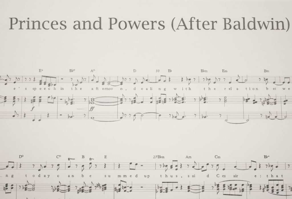 A detail of Princes and Powers (After Baldwin), part of Manifestos 3. The work is a graphite drawing on paper showing sheet music and lyrics.  Each musical notation corresponds with one or two letters.